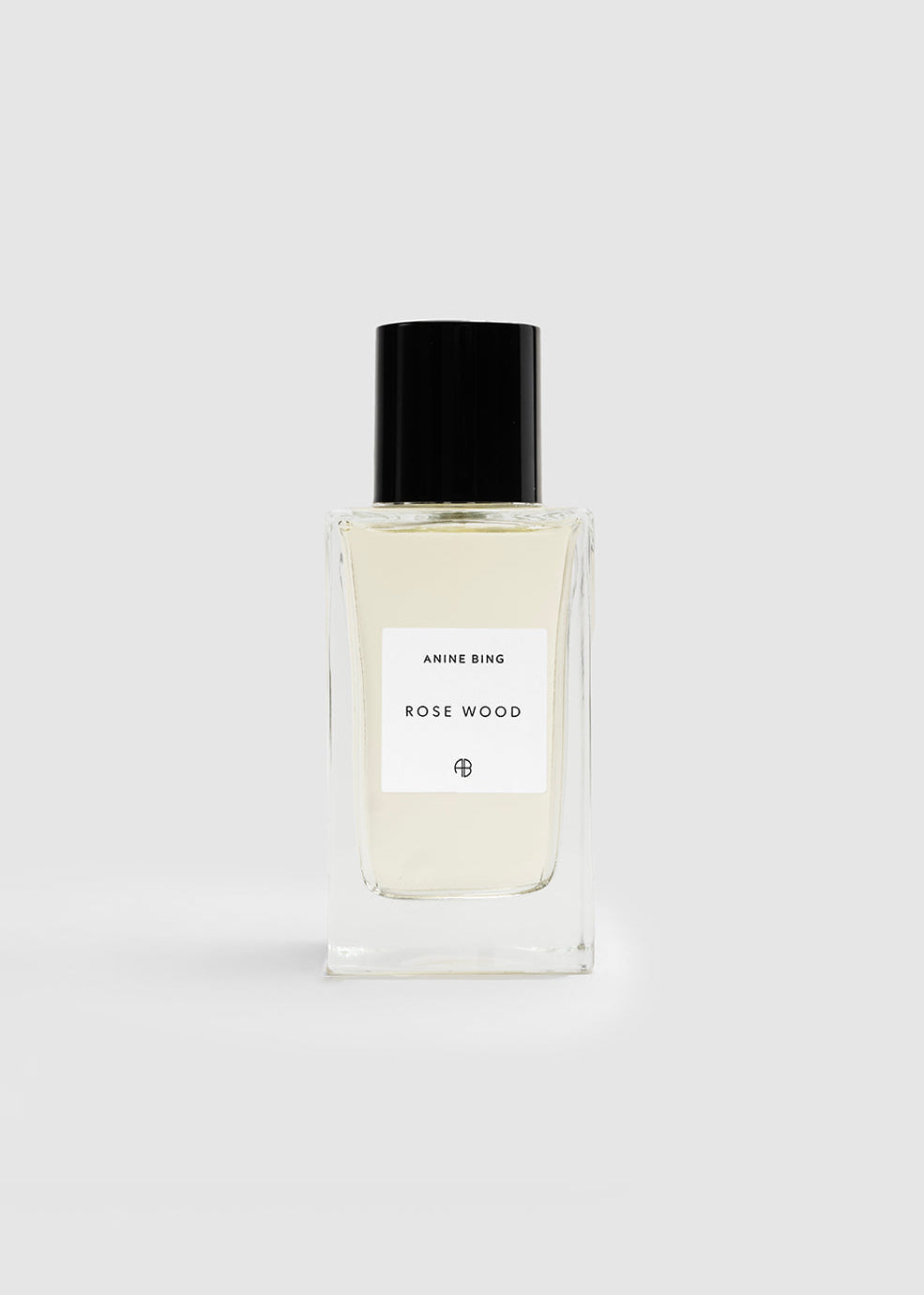 Perfume bottle labeled 'Rose Wood' on a white background