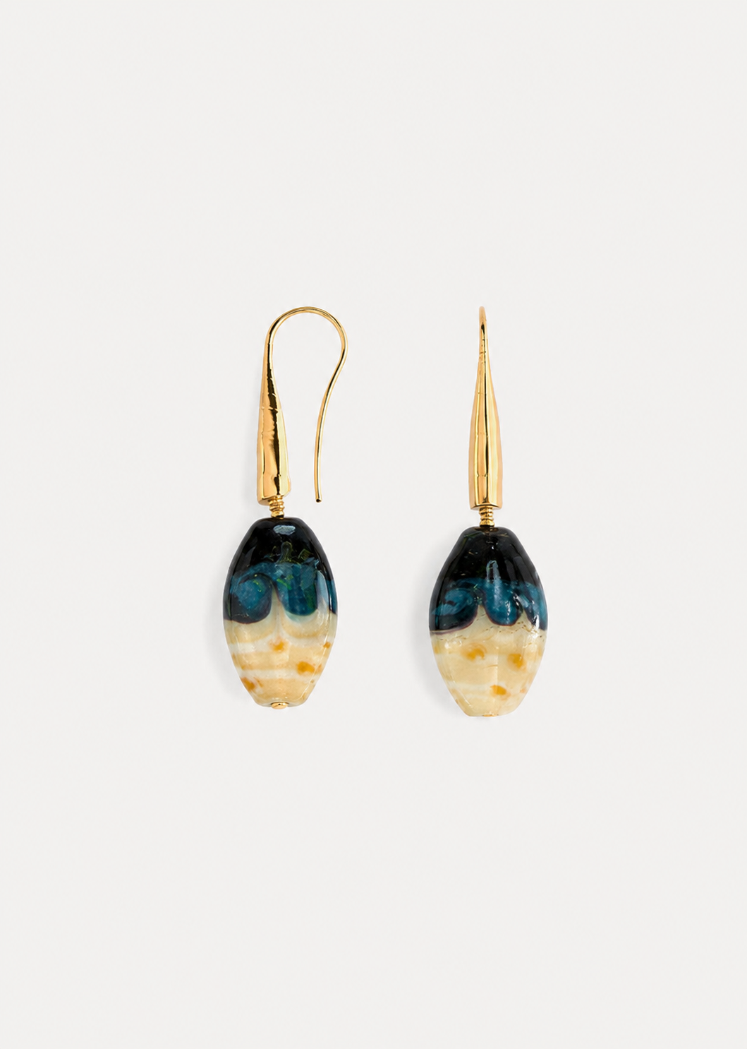 Pair of silver safety pin earrings on a white background