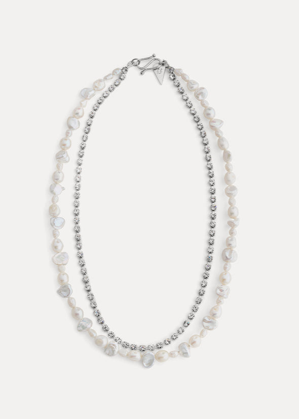 Two-layered pearl necklace with silver beads on a white background