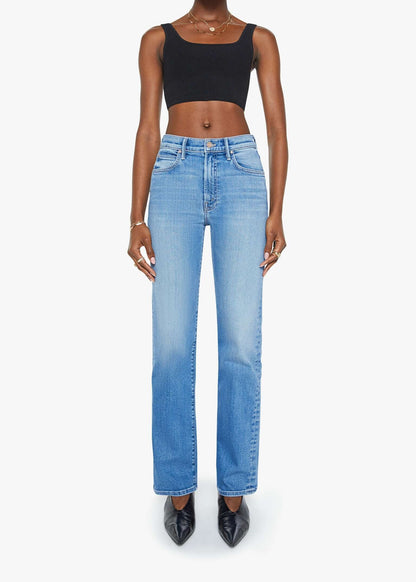 Person wearing blue jeans and a black top on a white background