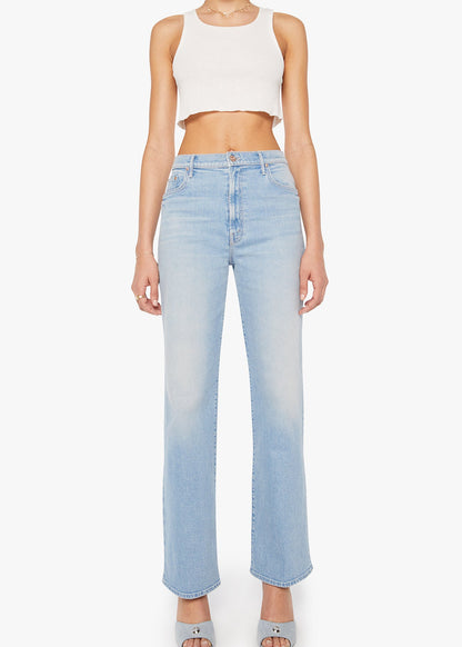 Person wearing light blue jeans and a white crop top on a white background