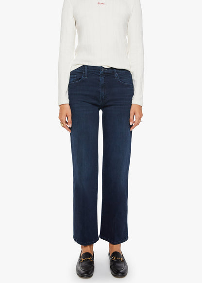 Person wearing a white long-sleeve shirt and dark blue jeans on a white background