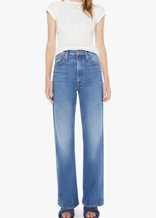 Person wearing blue jeans and a white top on a white background