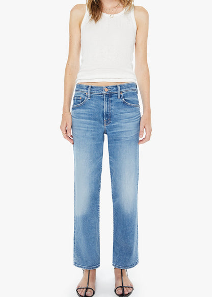 Woman wearing light blue jeans and a white sleeveless top on a white background