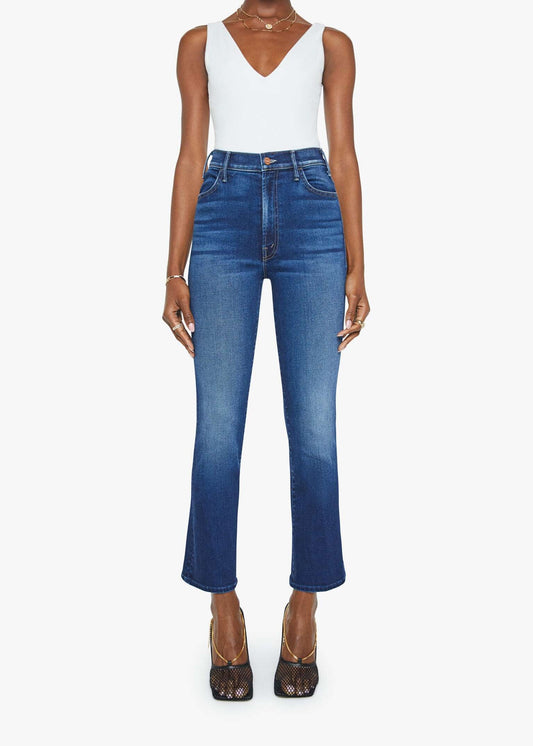 Person wearing blue jeans and a white top on a white background