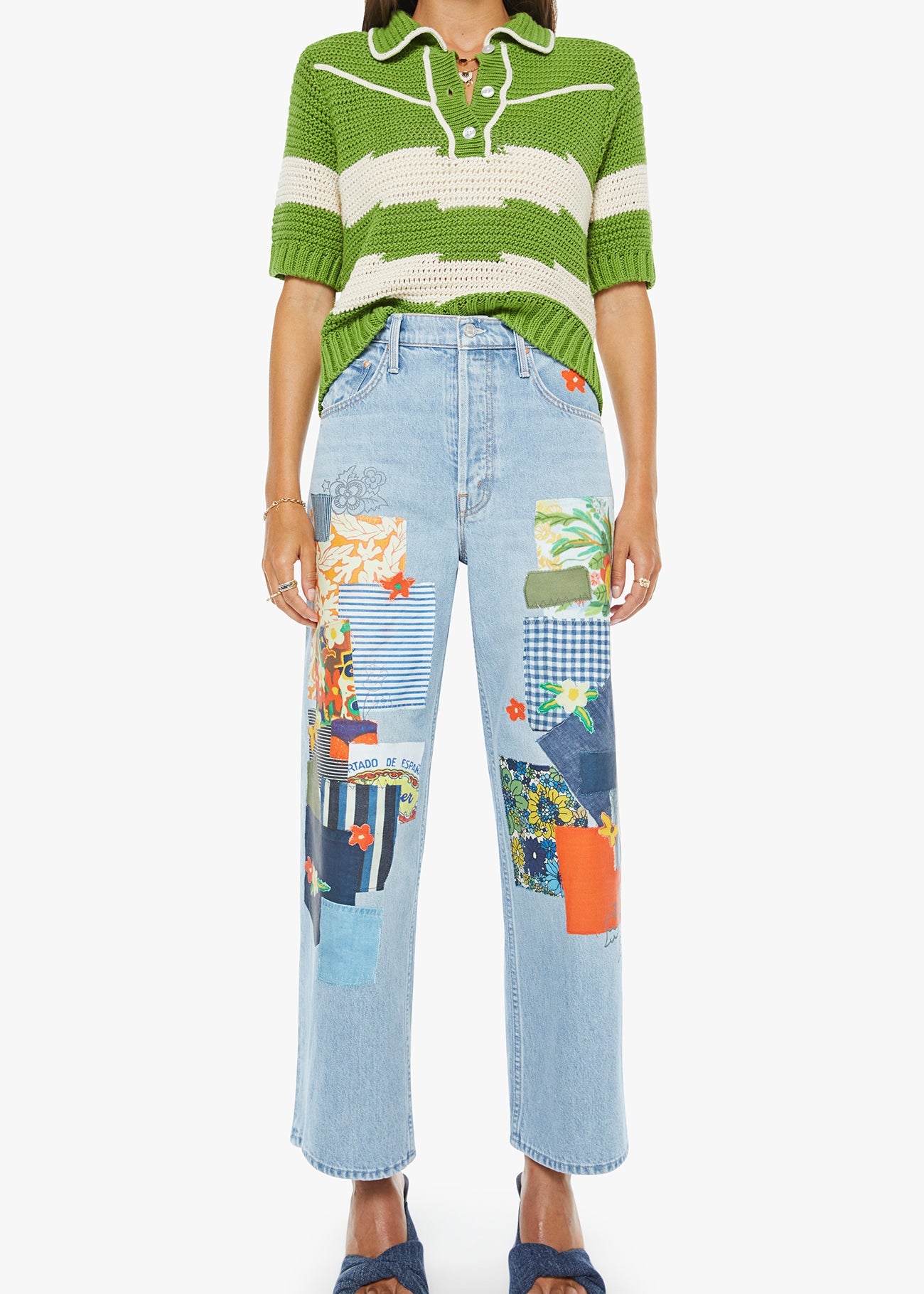 Person wearing a green and white striped shirt with patchwork jeans on a white background