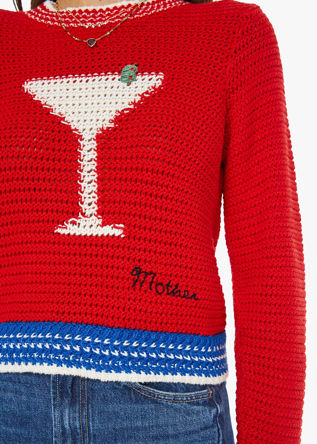 Red sweater with a martini glass design and 'Mother' branding.