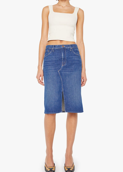 Person wearing a white top and blue denim skirt on a white background