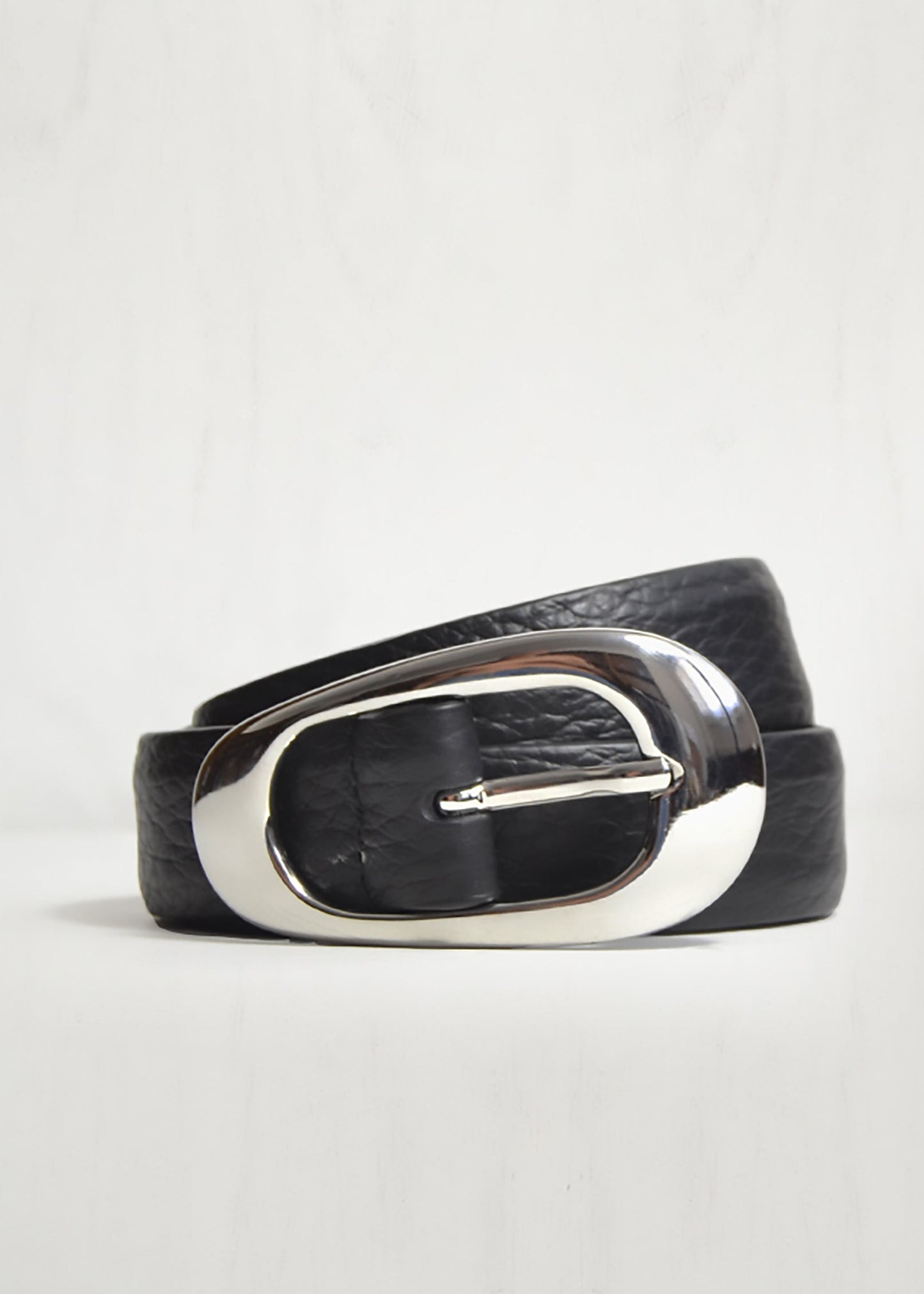 Black leather belt with a silver buckle on a light gray background