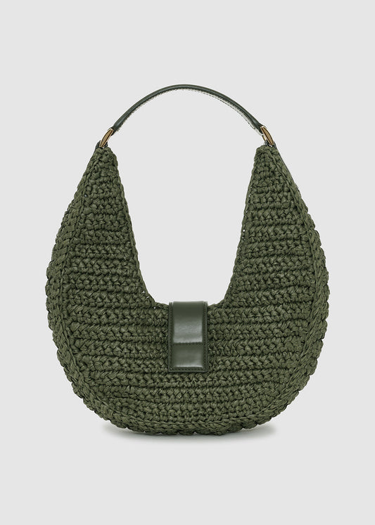 Green woven handbag with a black strap on a light gray background