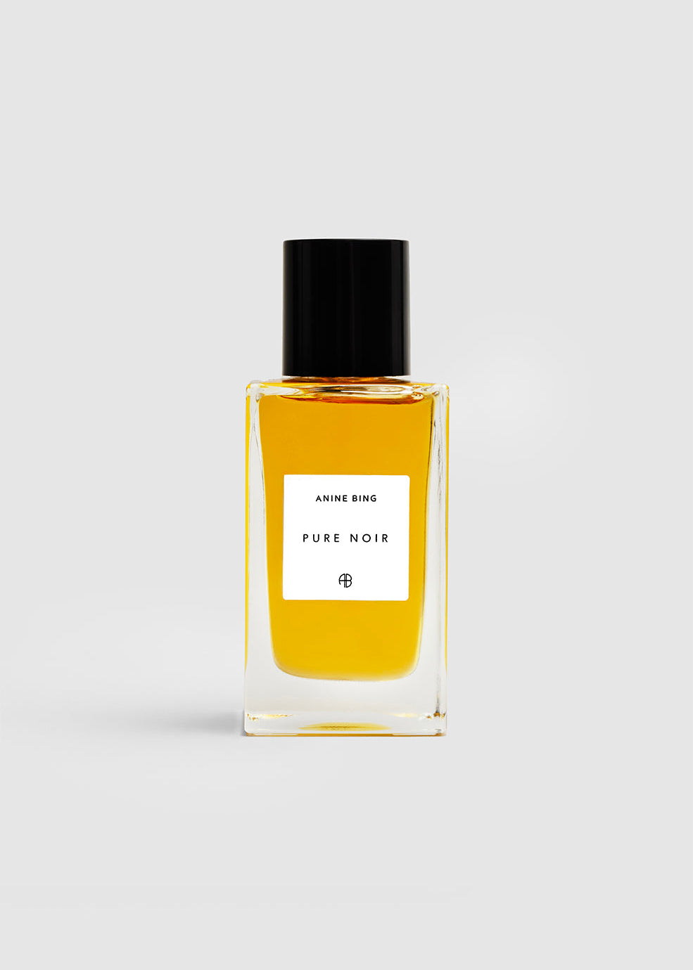 Perfume bottle labeled 'Pure Noir' on a light gray background