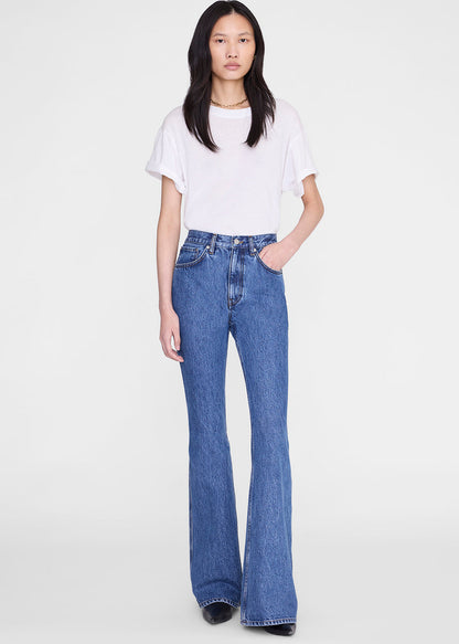 Person wearing a white t-shirt and blue jeans on a white background
