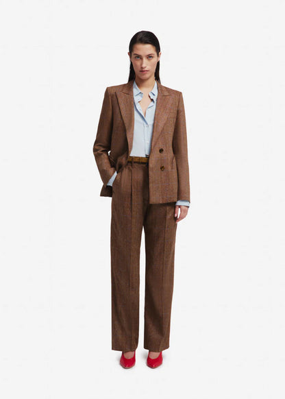 Woman wearing a brown suit with a white shirt on a white background
