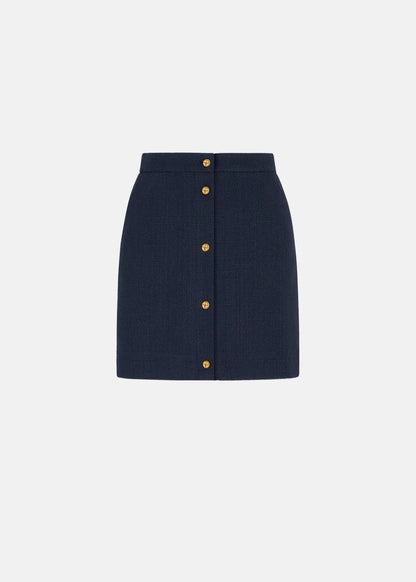 Navy blue skirt with gold buttons on a white background