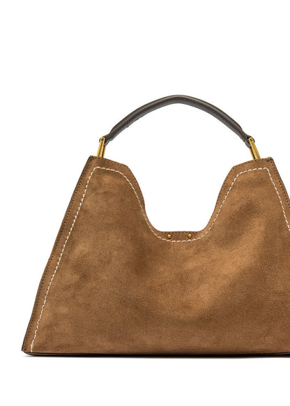 Brown handbag with a black handle on a white background