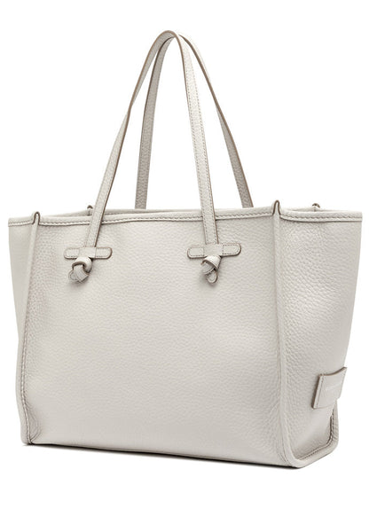 White handbag with a textured surface on a white background