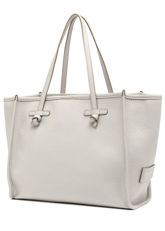 White handbag with a textured surface on a white background