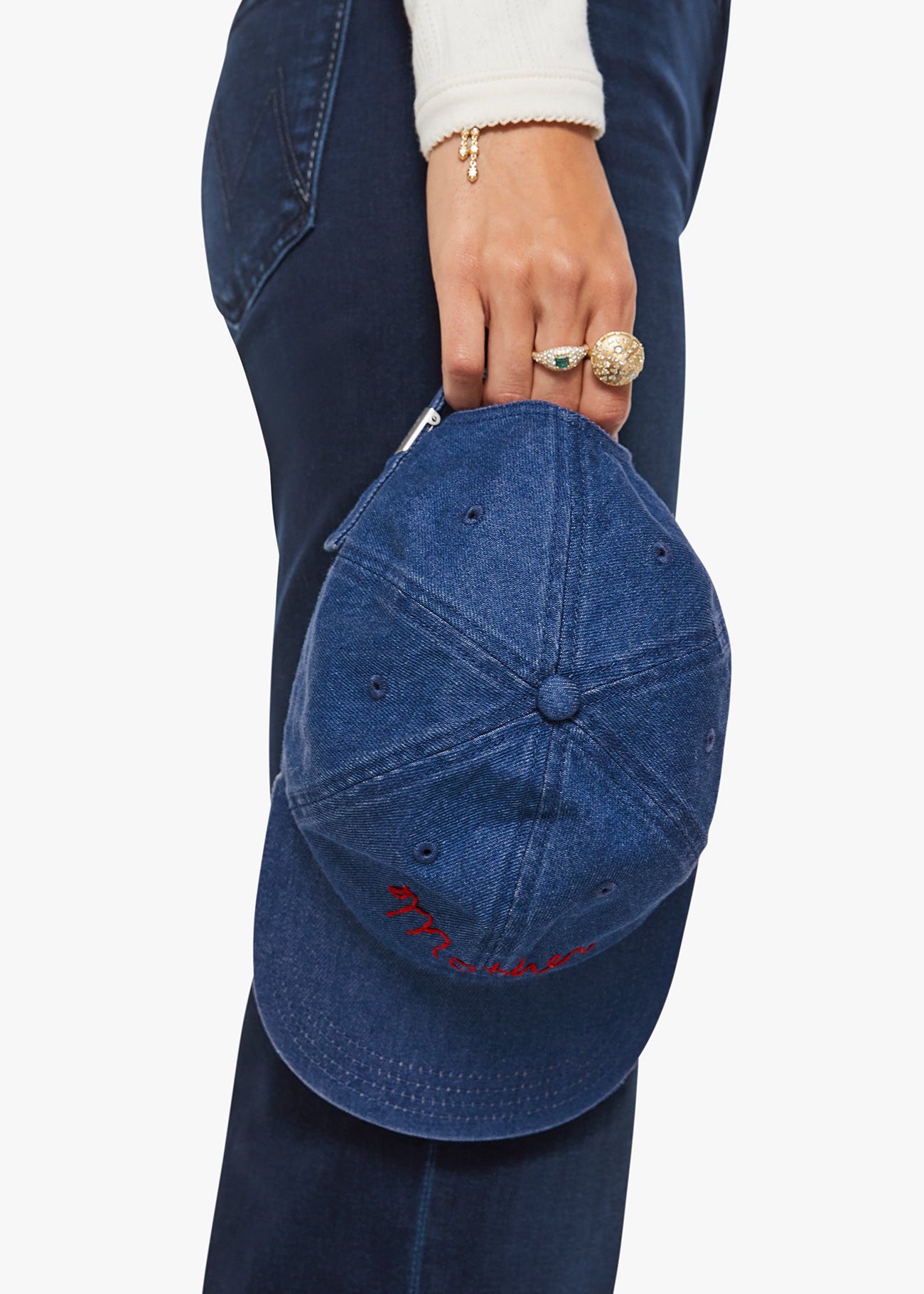 Person holding a blue cap with a plain background