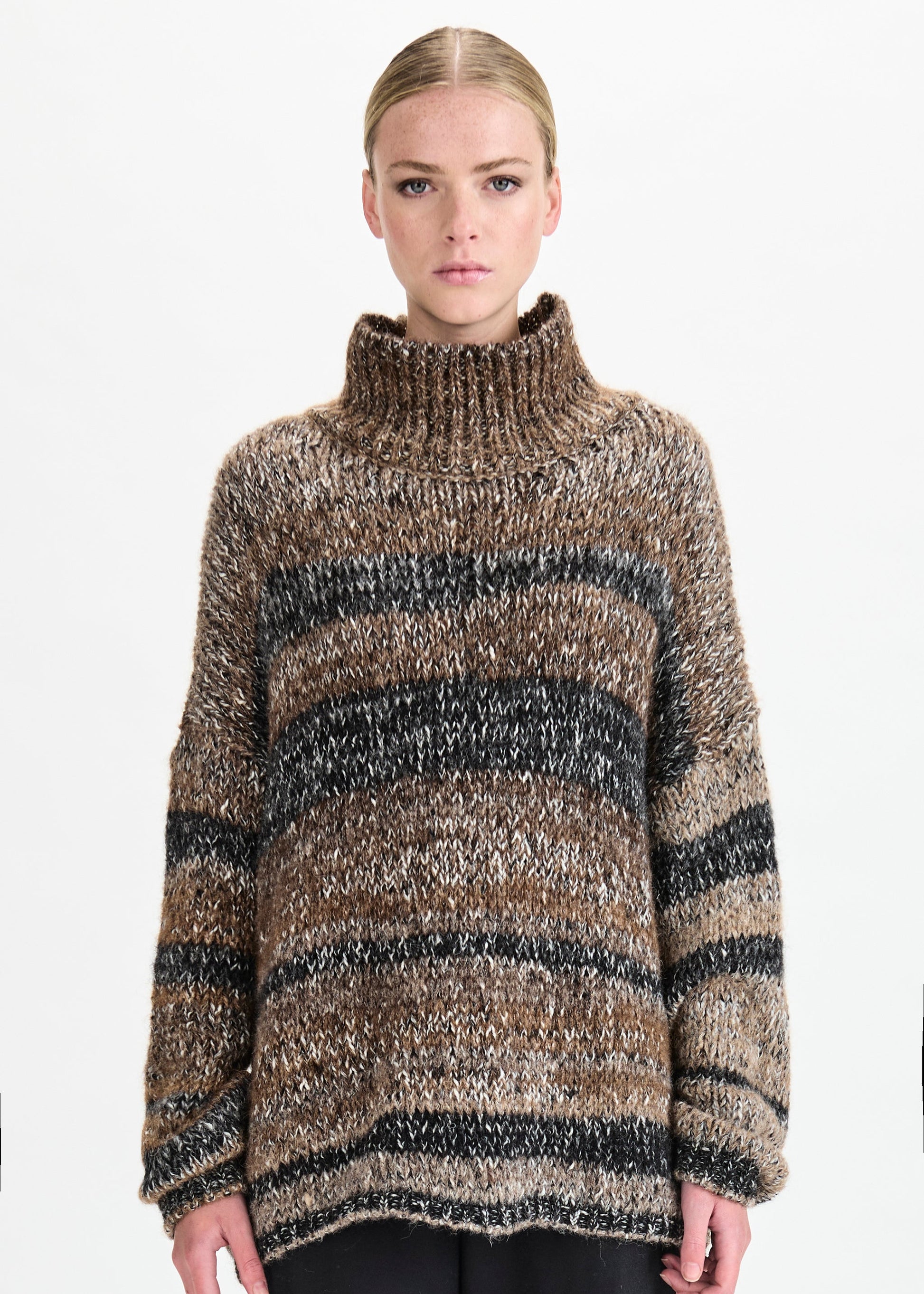 Person wearing a striped sweater on a white background