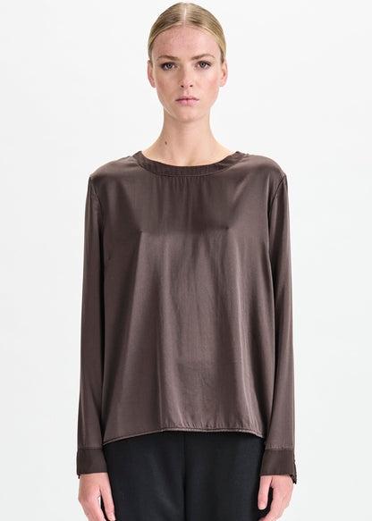 Woman wearing a brown blouse on a white background