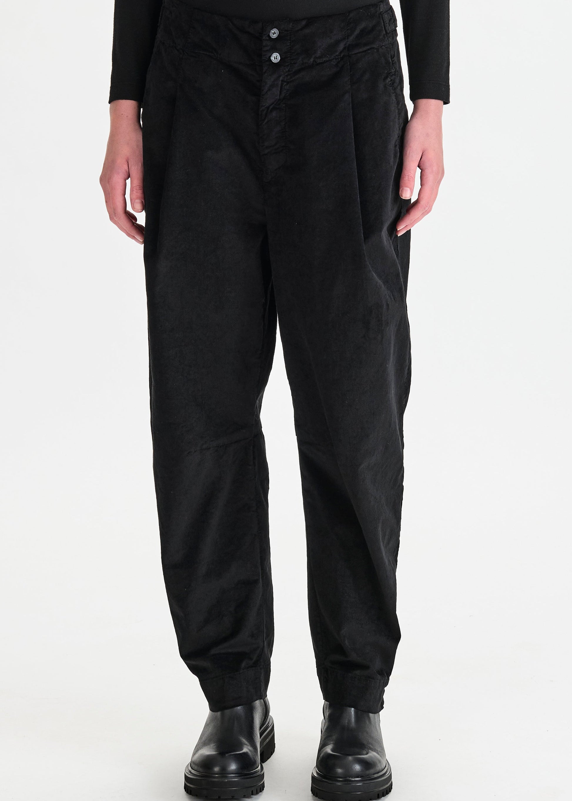 Person wearing black pants on a white background