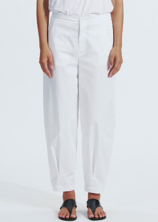 Person wearing white pants on a plain background