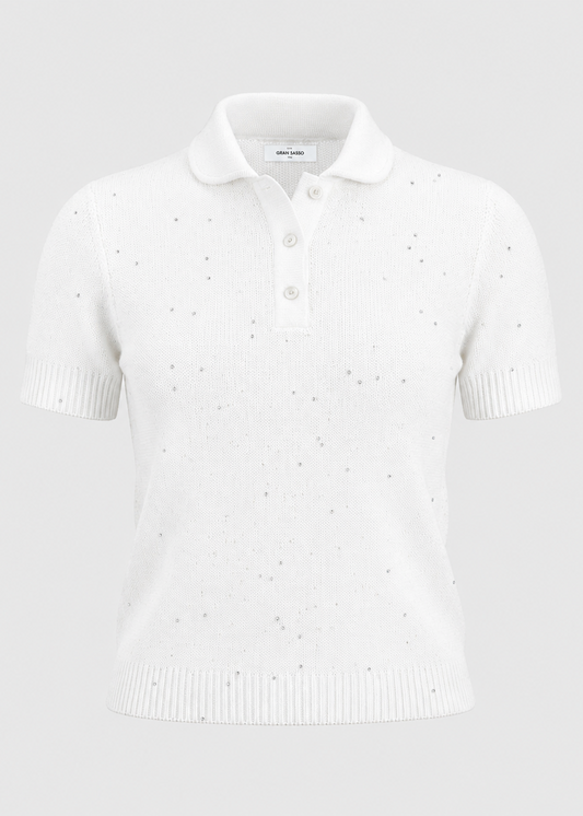 A white short-sleeve knit polo shirt with subtle dotted eyelet embroidery and ribbed collar, placket, and hem, shown on a light gray background.