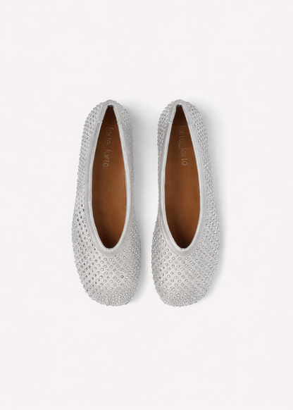 Pair of silver embellished flats on a light gray background