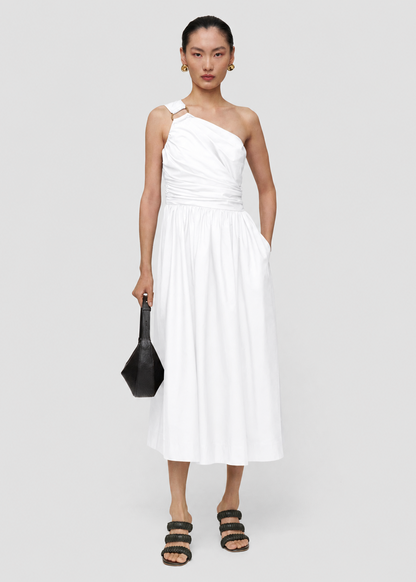 Woman wearing a white one-shoulder dress on a plain background