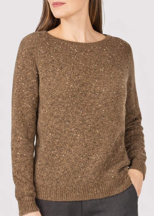 Khaki sweater worn by a person on a light gray background
