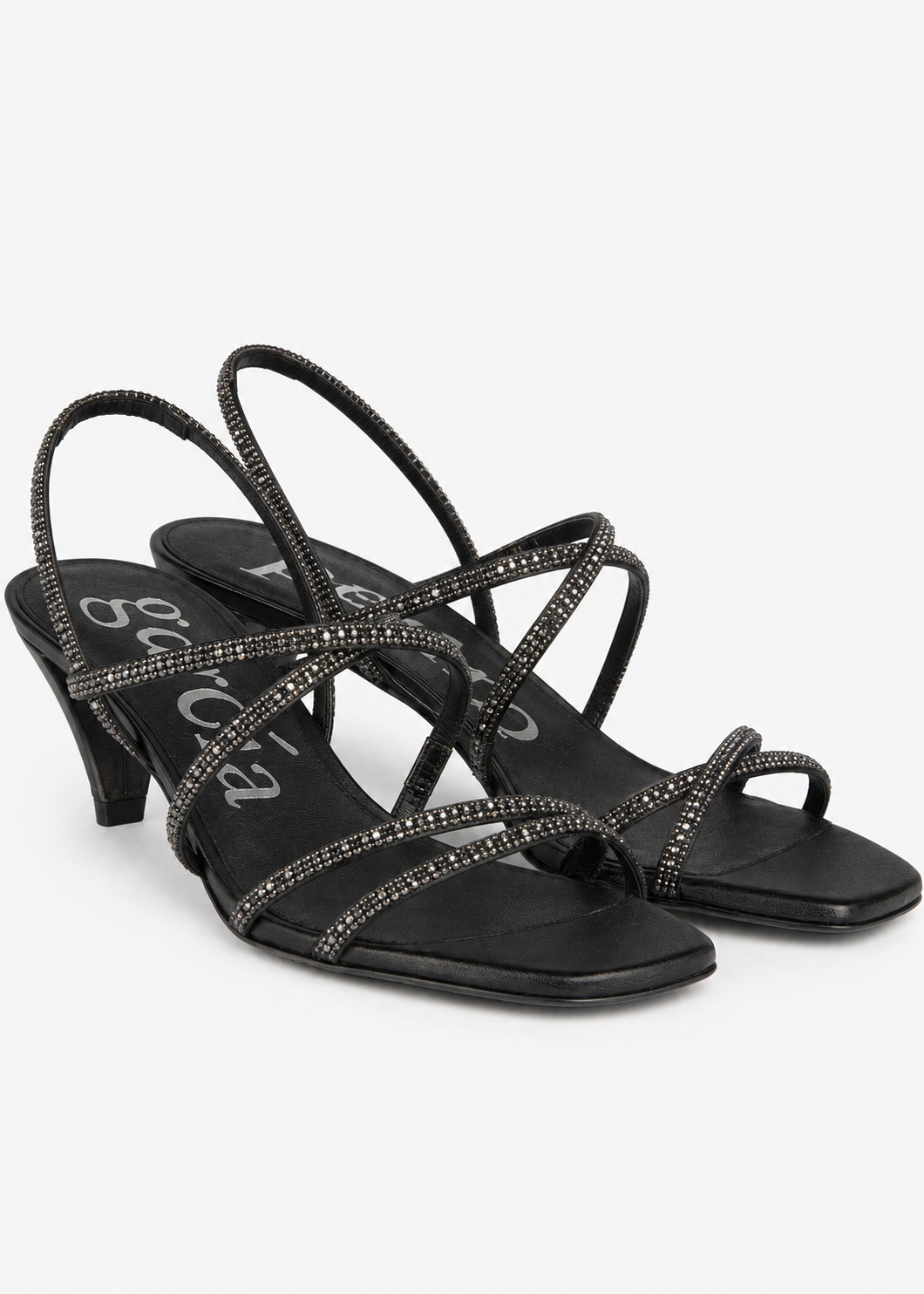A pair of black strappy high-heeled sandals embellished with sparkling rhinestones, shown against a plain light gray background.