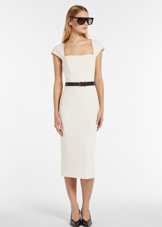 Woman wearing a white dress with a black belt on a white background