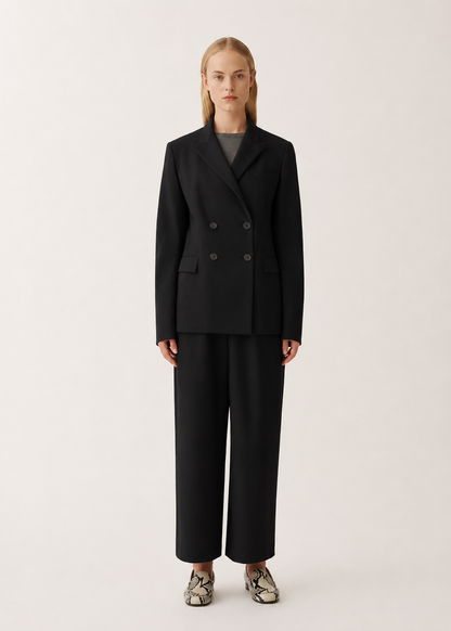 Person wearing a black suit on a white background