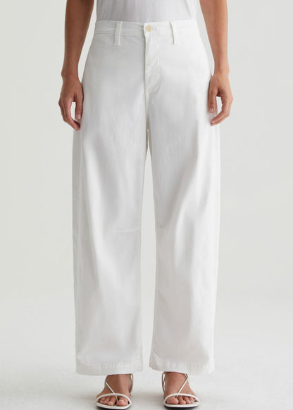 Person wearing white wide-leg pants on a plain background
