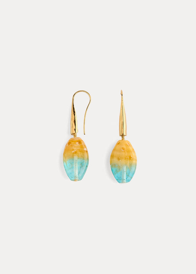 A pair of gold-tone drop earrings with teardrop-shaped beads featuring a yellow-to-blue gradient, shown on a light gray background.