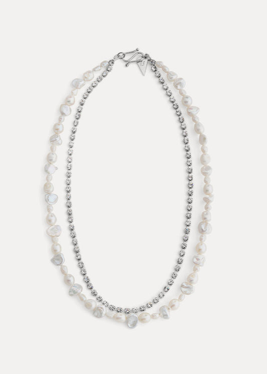 Two-layered pearl necklace with silver beads on a white background