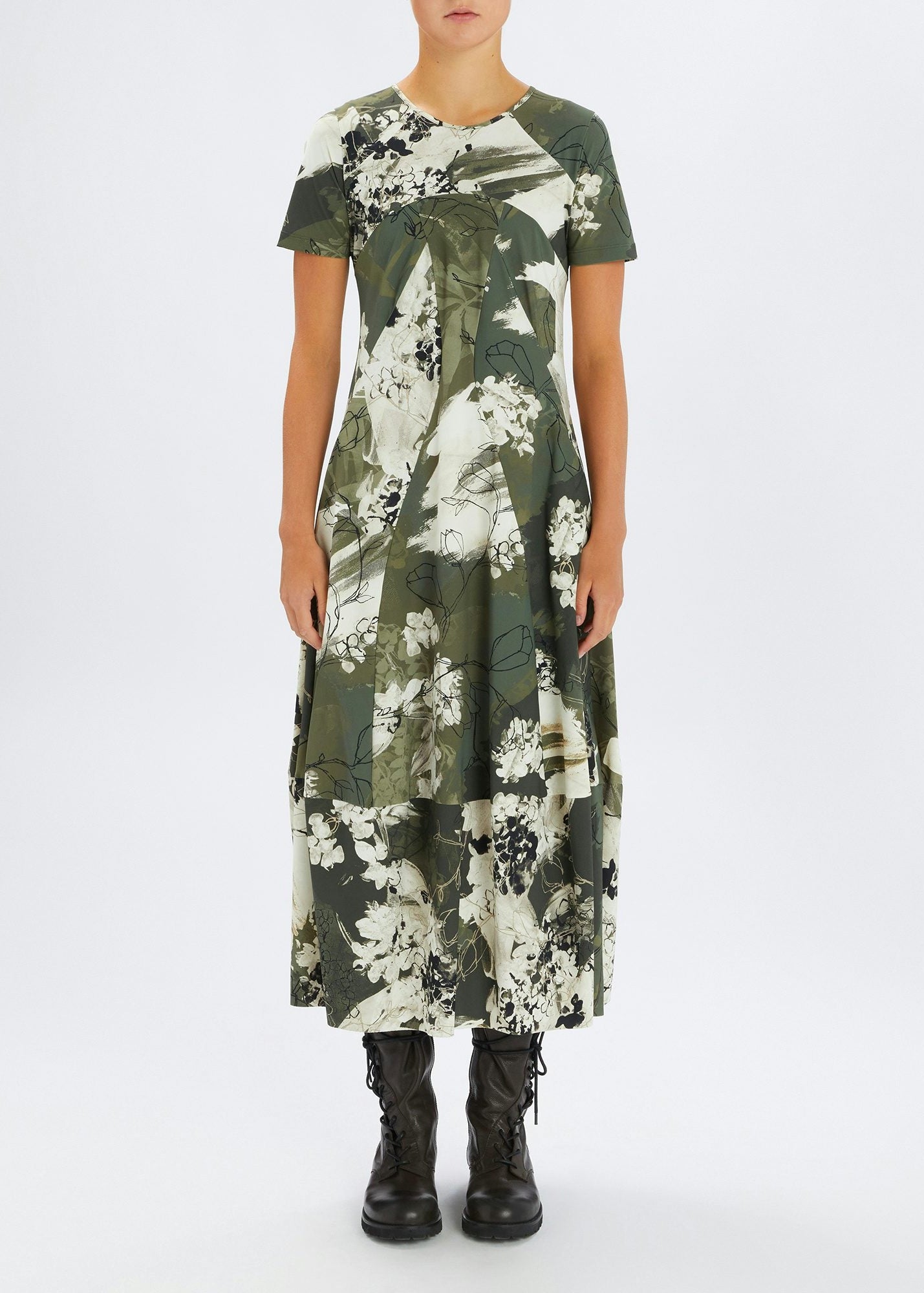 Person wearing a green floral dress on a white background