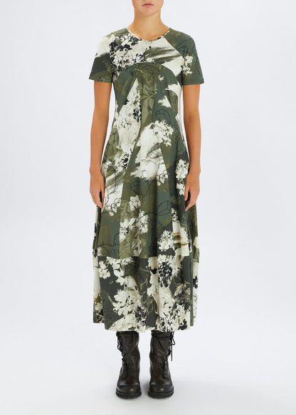 Person wearing a green floral dress on a white background