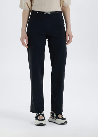 Person wearing black pants on a white background