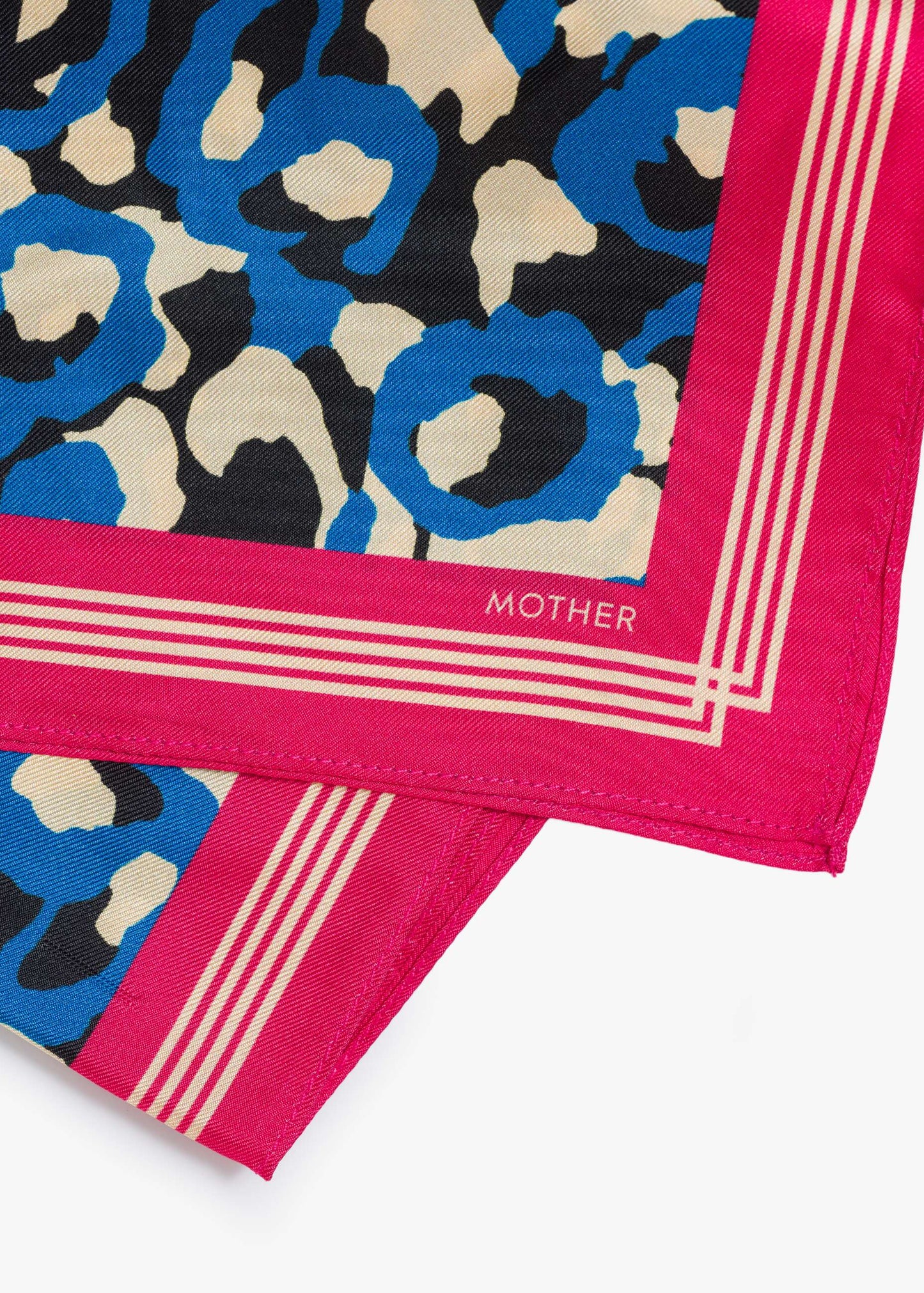 Patterned fabric with blue, beige, and black design on a pink border, featuring the brand 'Mother'.