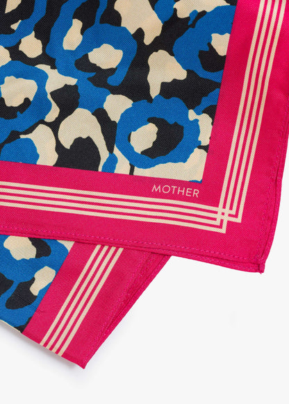 Patterned fabric with blue, beige, and black design on a pink border, featuring the brand 'Mother'.