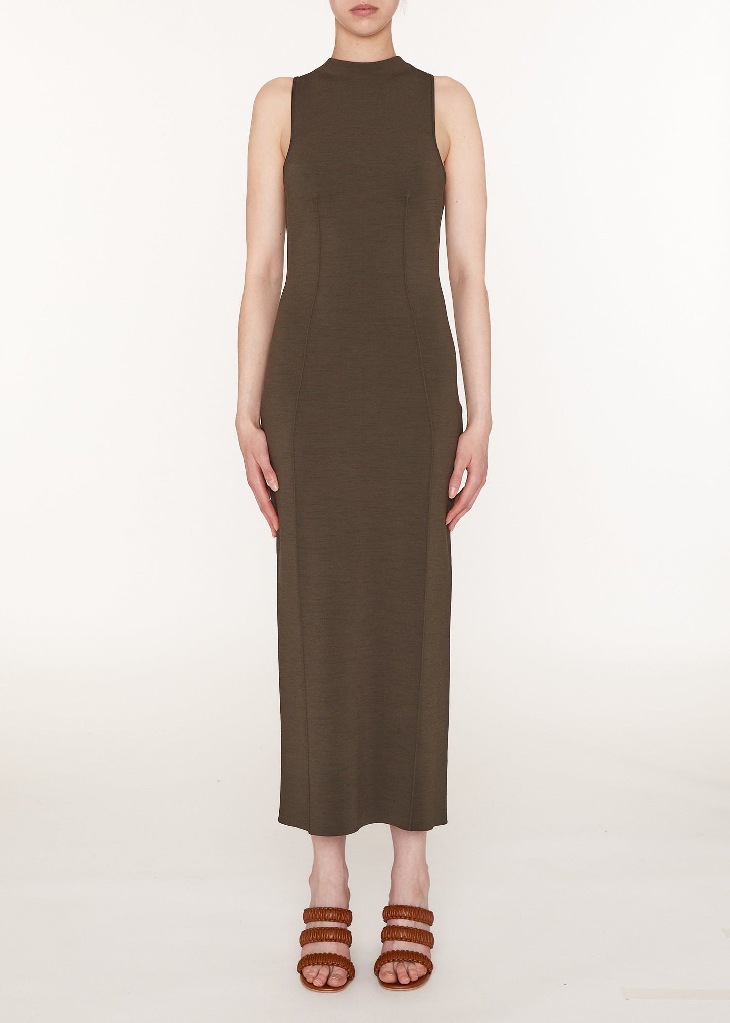 Woman wearing a brown sleeveless dress on a white background