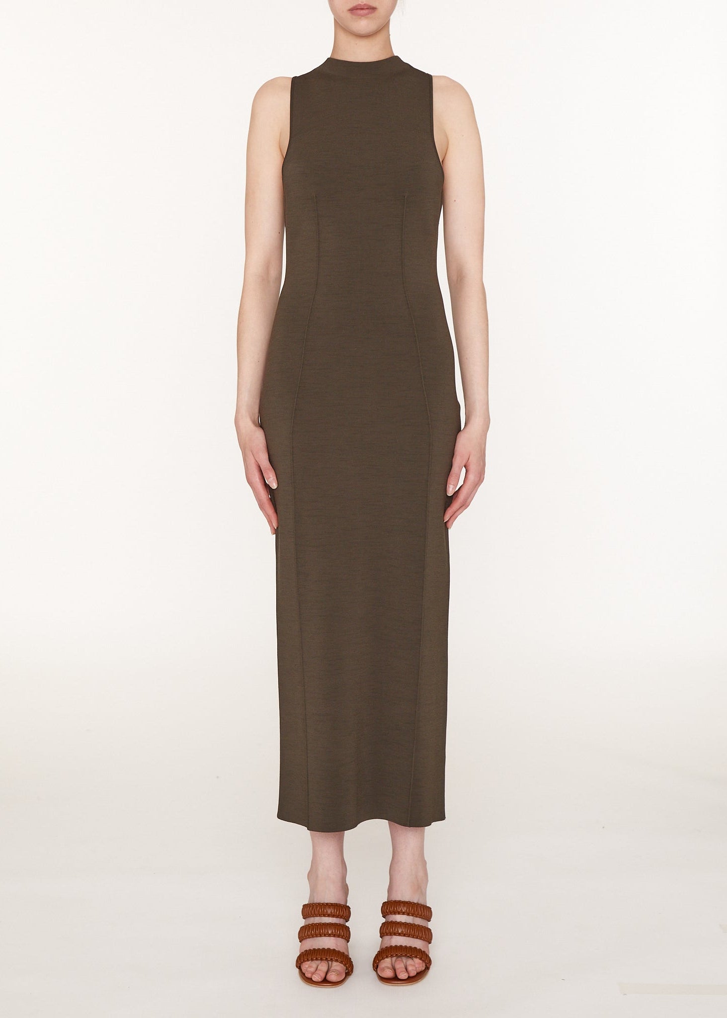Woman wearing a brown sleeveless dress on a white background