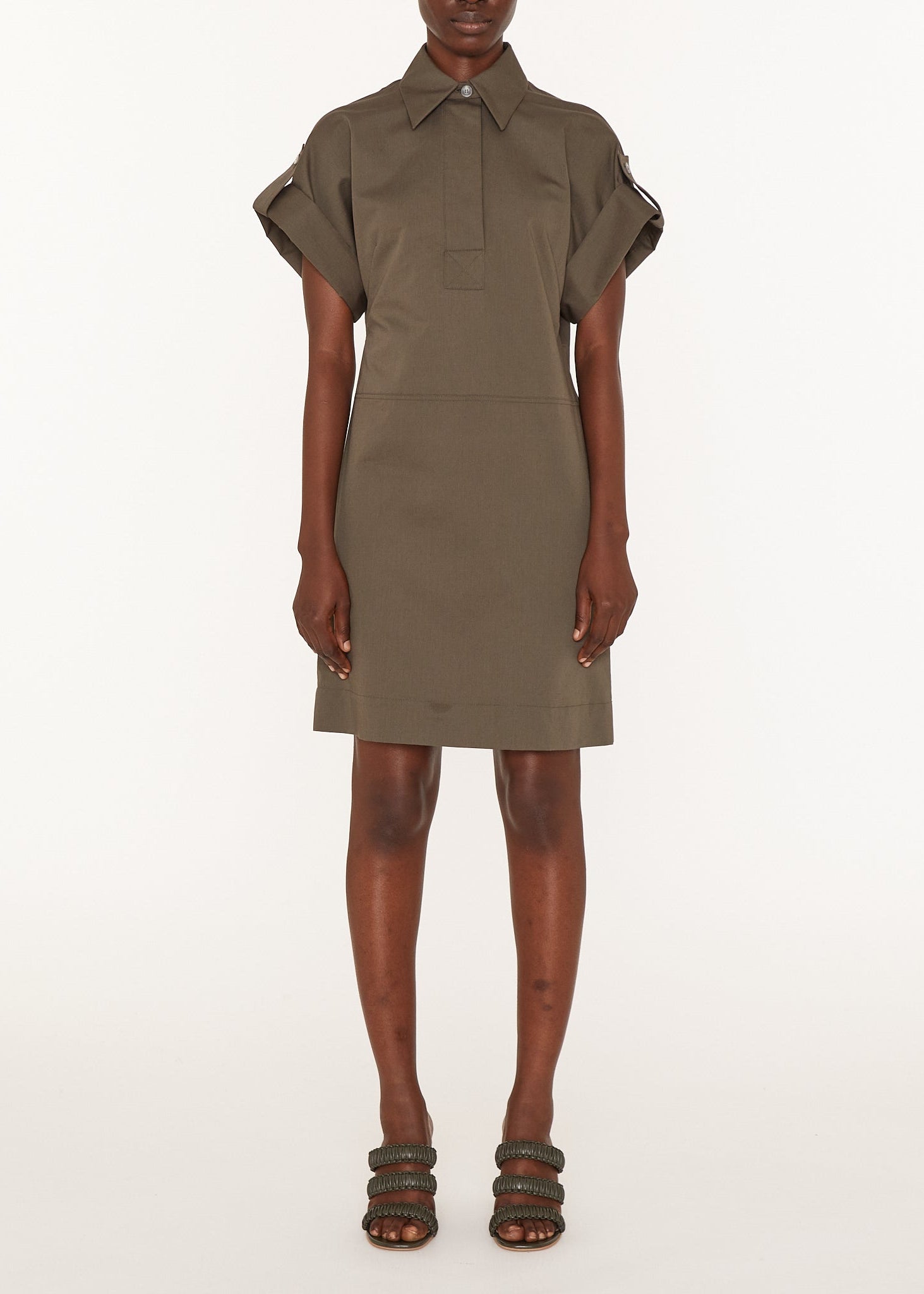Person wearing a green dress on a white background