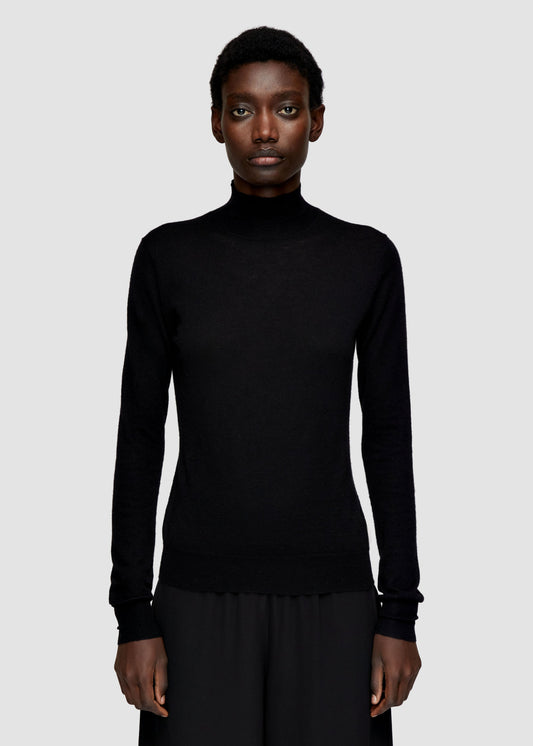 Person wearing a black turtleneck sweater on a light gray background