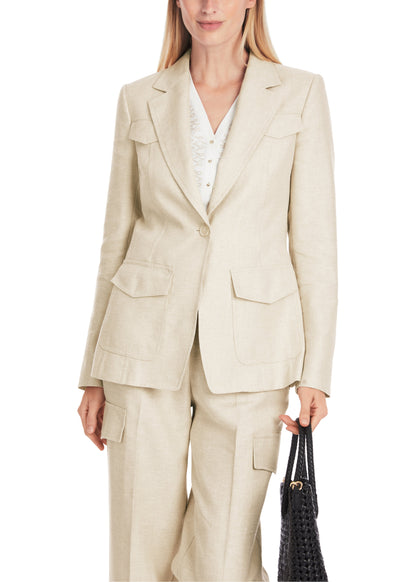Woman wearing a beige suit holding a black handbag on a white background