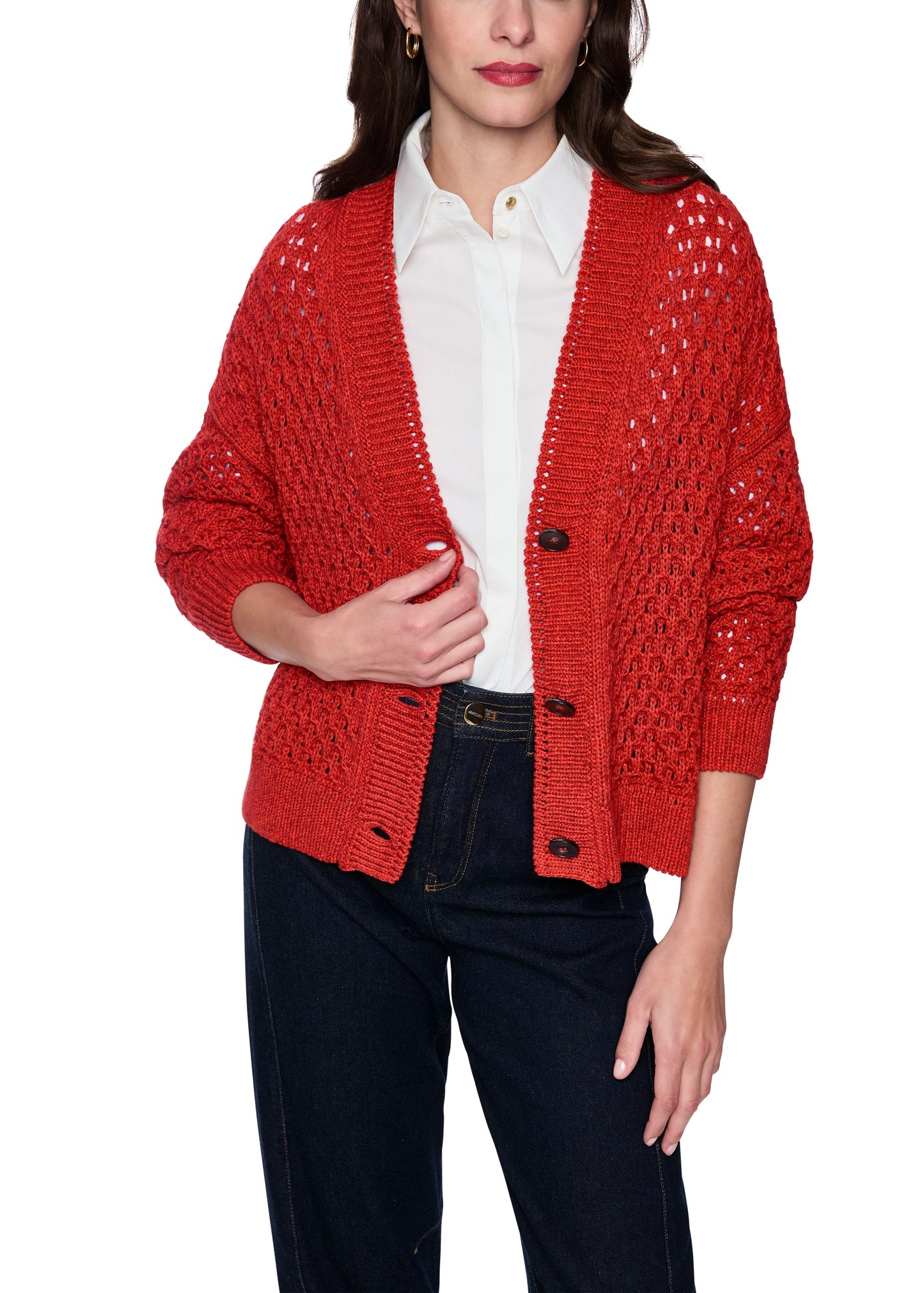 Person wearing a red knitted cardigan over a white shirt on a white background