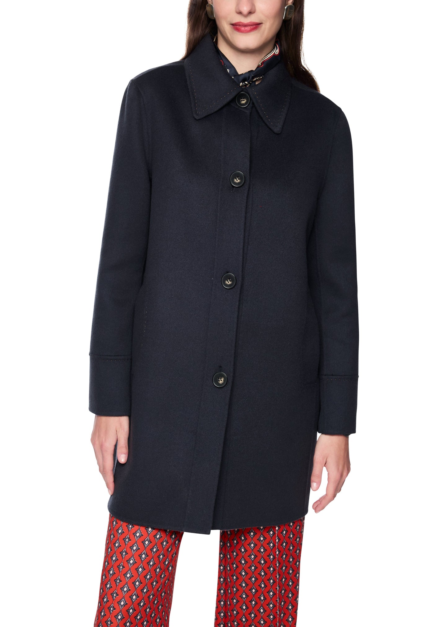 Navy coat worn by a person on a white background