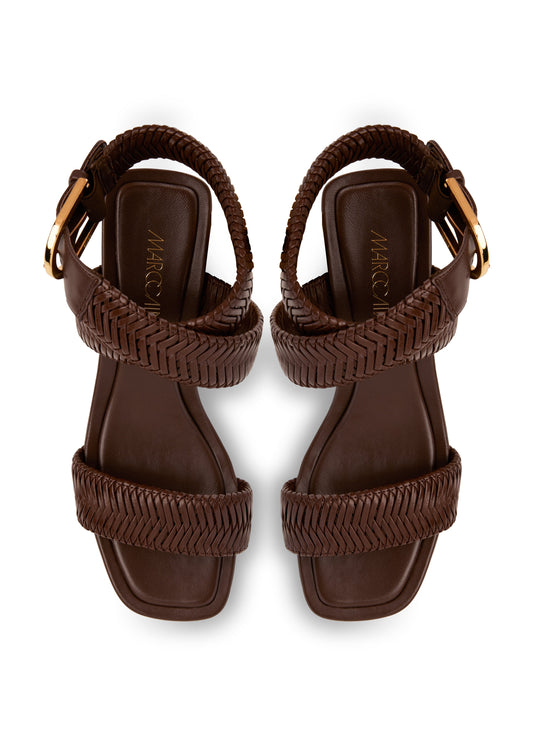 Pair of brown sandals with braided straps on a white background