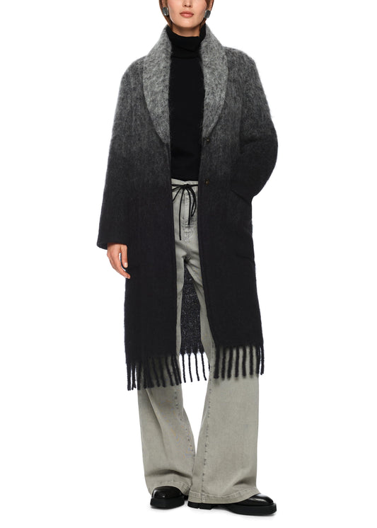 Person wearing a long black and gray coat with a scarf on a white background